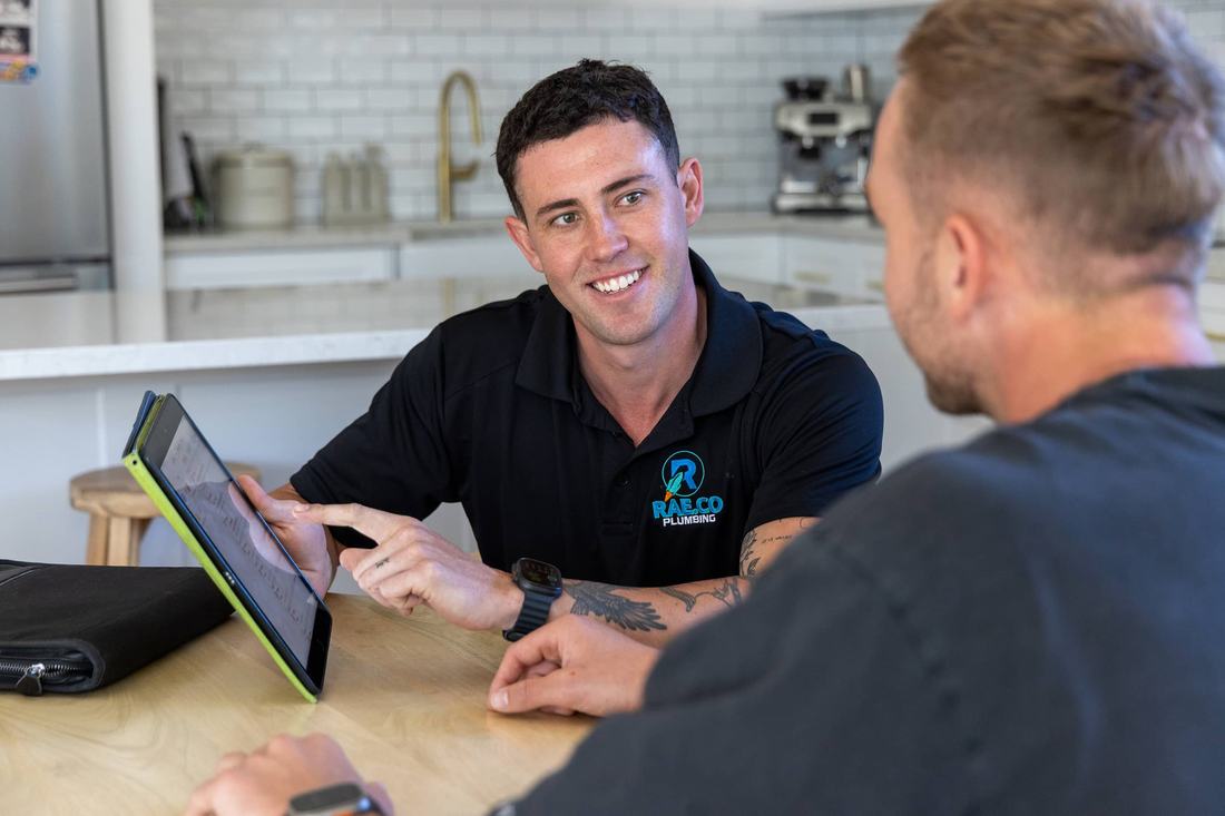 Rae.co plumber walking a homeowner through maintenance options