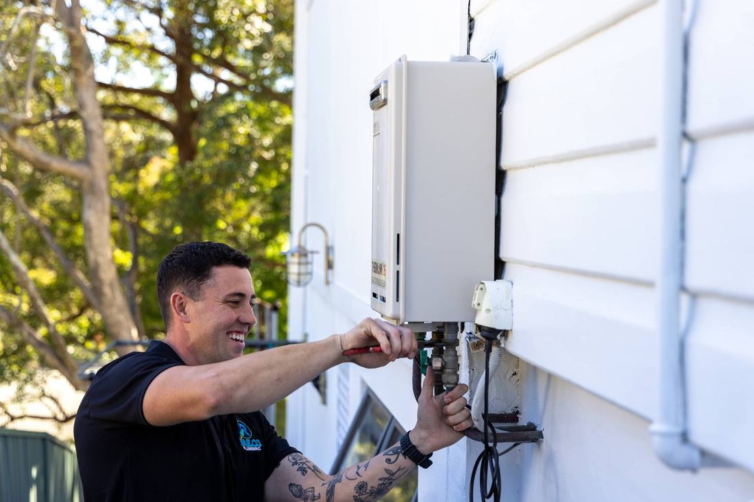 Rae.co plumber repairing a fixture on an exterior wall